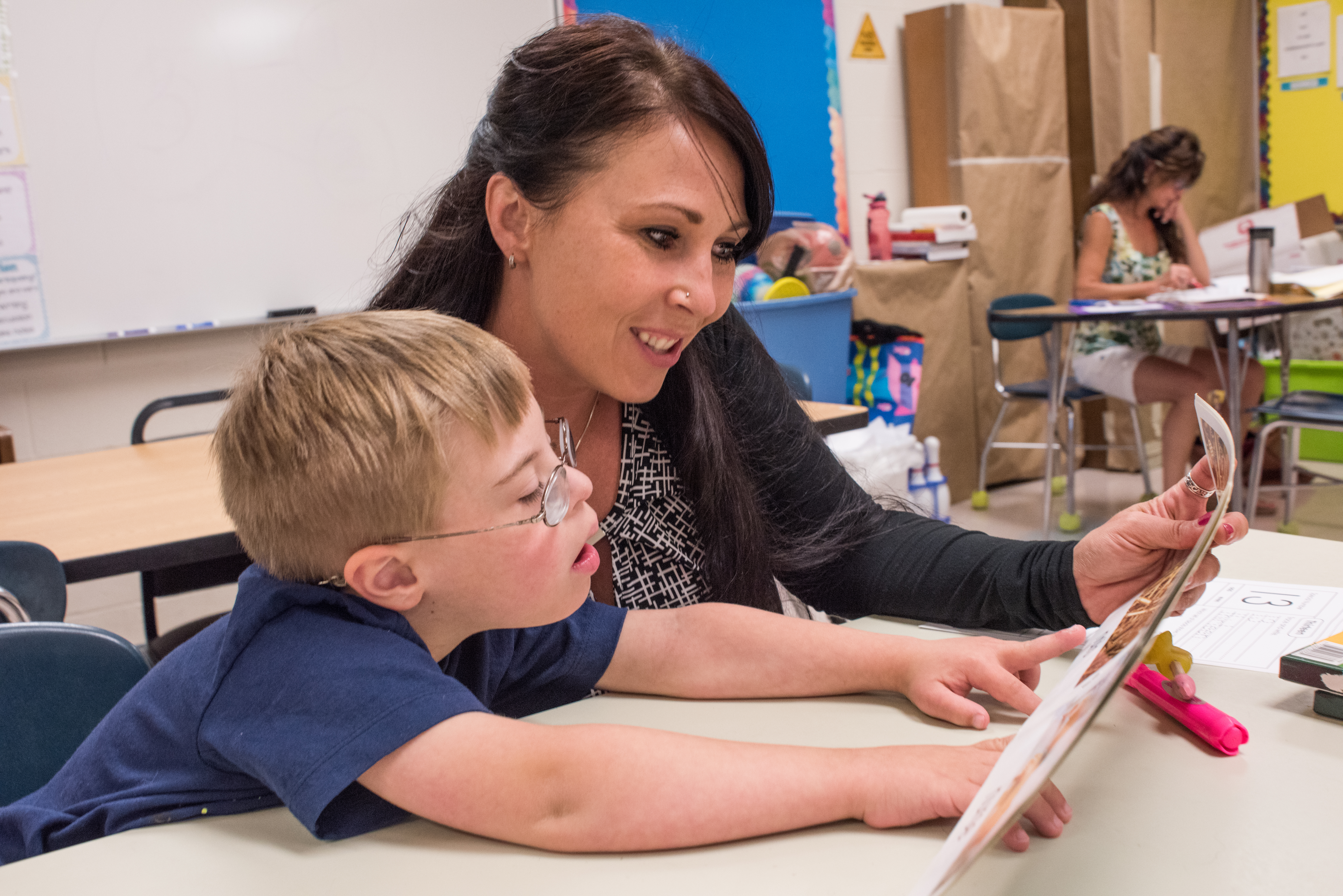 female teacher working with student